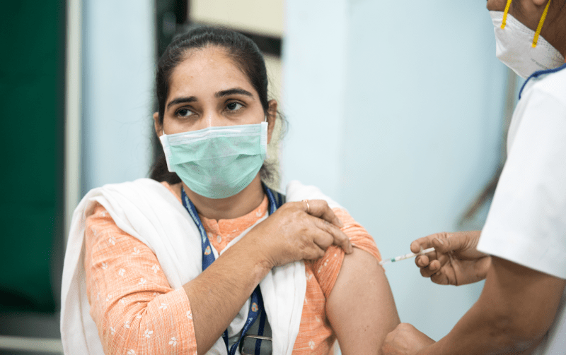 A Women Taking Vaccine Precaution Dose